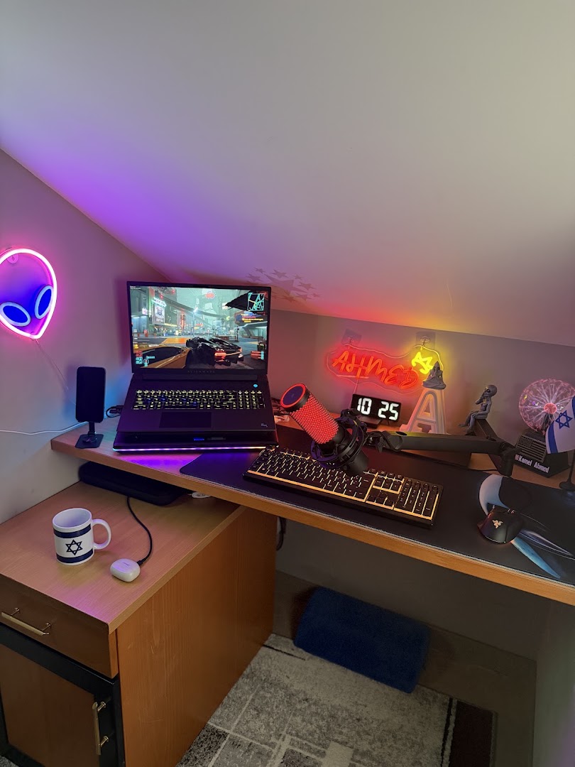 Ahmed’s Alienware laptop and gaming desk with colourful lighting